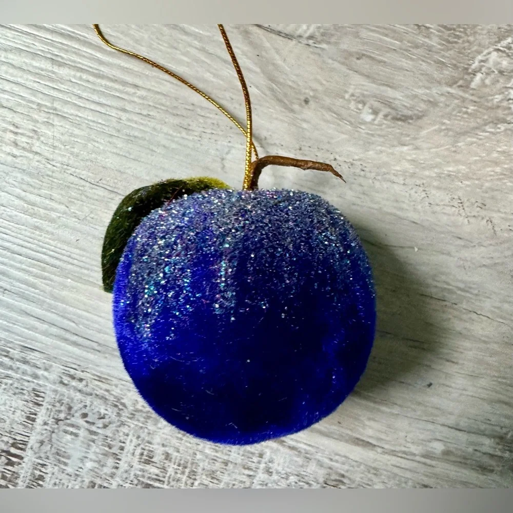 Christmas tree ornament. A plum-shaped ornament covered in glitter. The ornament